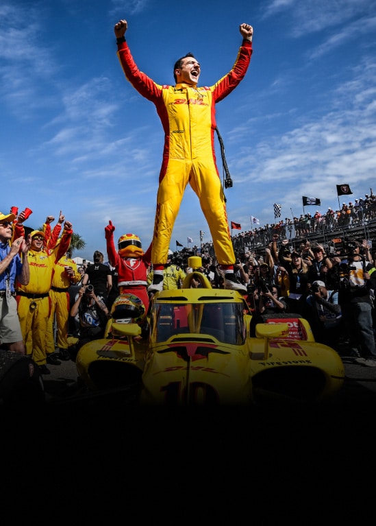 2026 Honda finishes 1st in St. Petersburg, with Alex Palou standing on the car celebrating the victory.