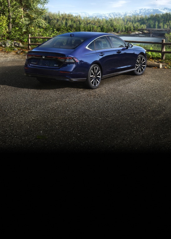 2026 Honda Accord Touring Hybrid in Canyon River Blue Metallic parked rear near a wooden fence (Mid-Size Sedan)