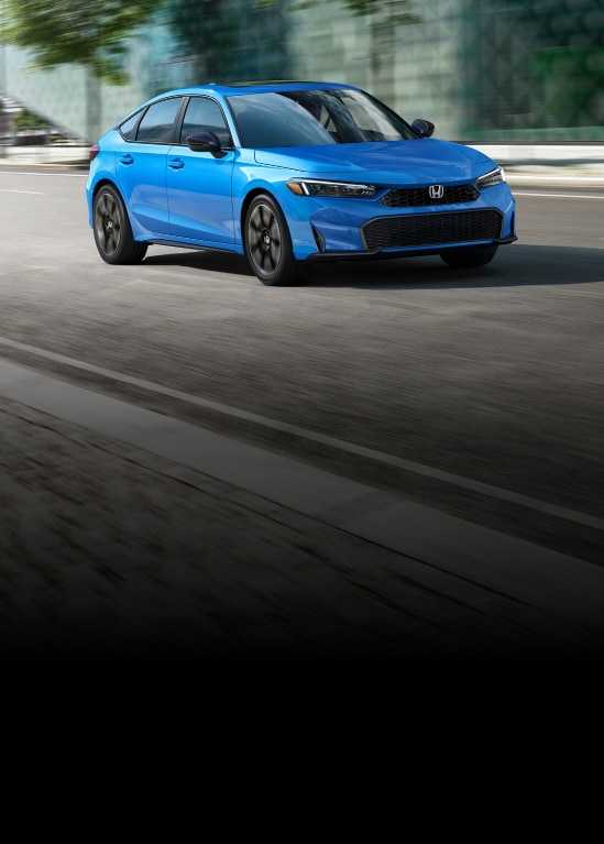2027 Honda Civic Hatchback Sport Touring Hybrid in Boost Blue Pearl front driving on a city street (Compact Hatchback).