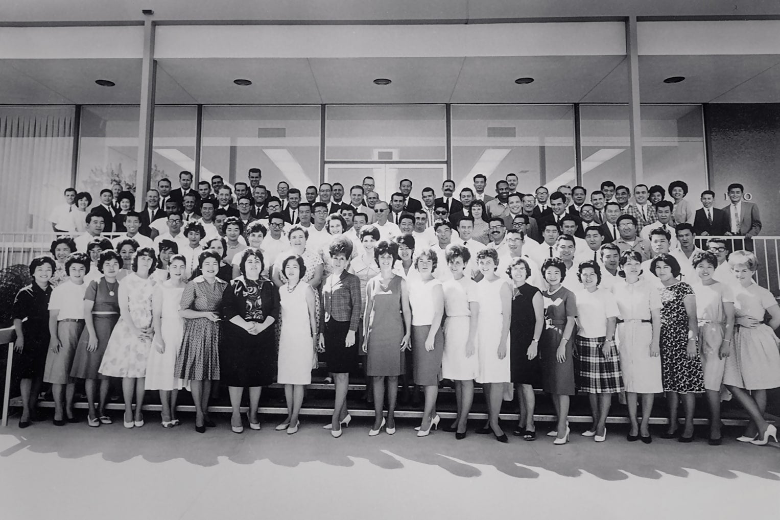 Honda employees posing for a corporate photo in a nostalgic vintage style.